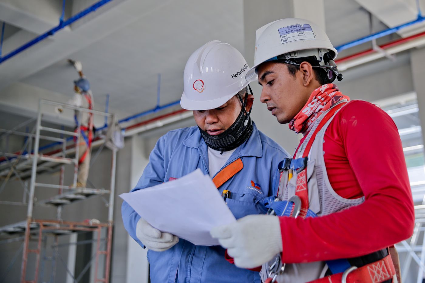 Licensed trades reviewing plans on a Sydney job site